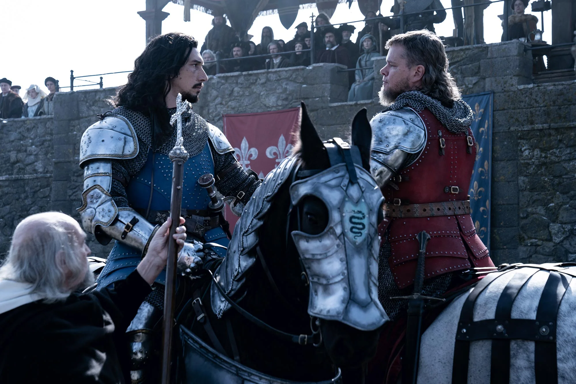 A still from 'The Last Duel' of Jean and Jacques on their horses and clad in armor, shaking hands before they duel